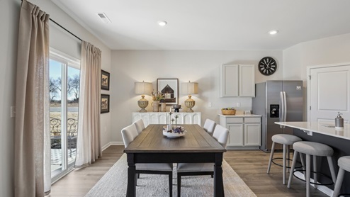 Dining room in new, open-concept home with windows and natural lighting