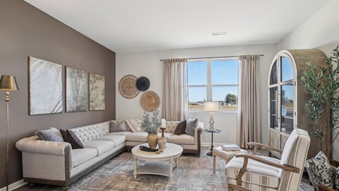 Living room in new, open-concept home with windows and natural lighting