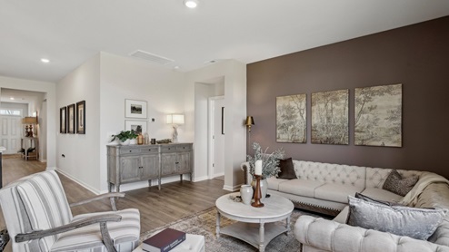 Living room in new, open-concept home with windows and natural lighting