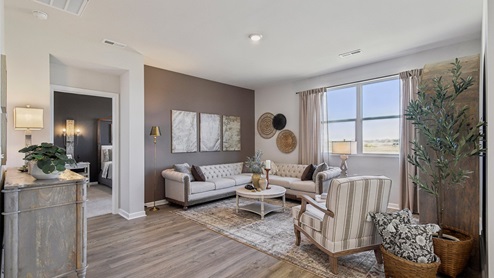 Living room in new, open-concept home with windows and natural lighting