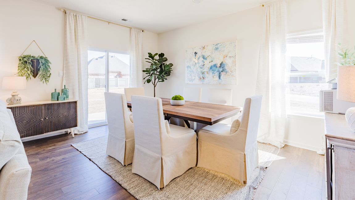 Dining room in new, open-concept home with windows and natural lighting