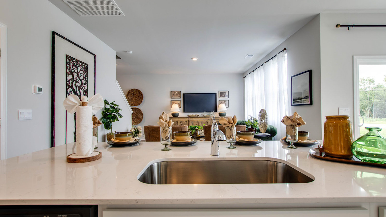 Spacious kitchen with white cabinetry, large island and stainless steel appliances