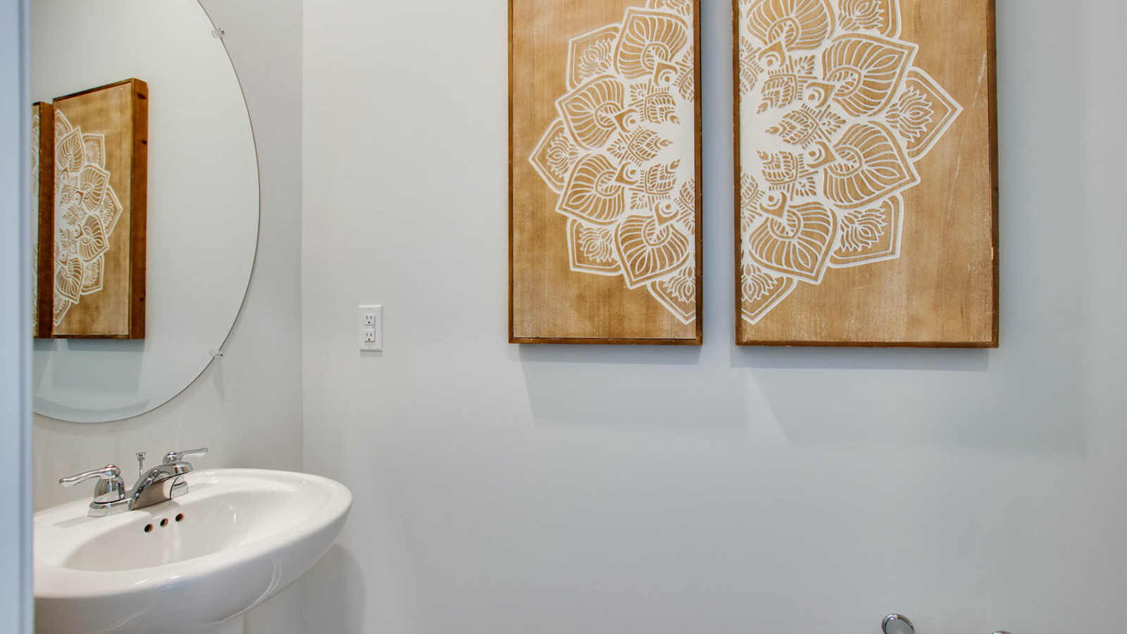 Powder bathroom with a pedestal sink and mirror