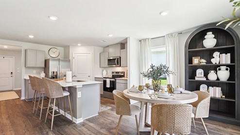 Dining room in new, open-concept home with windows and natural lighting