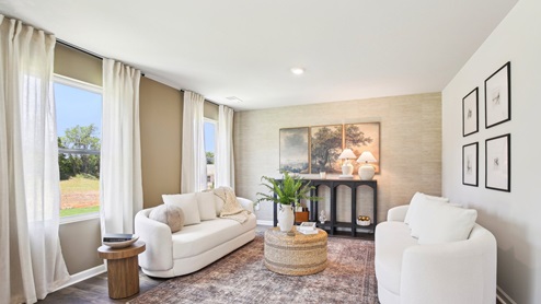 Living room in new, open-concept home with windows and natural lighting