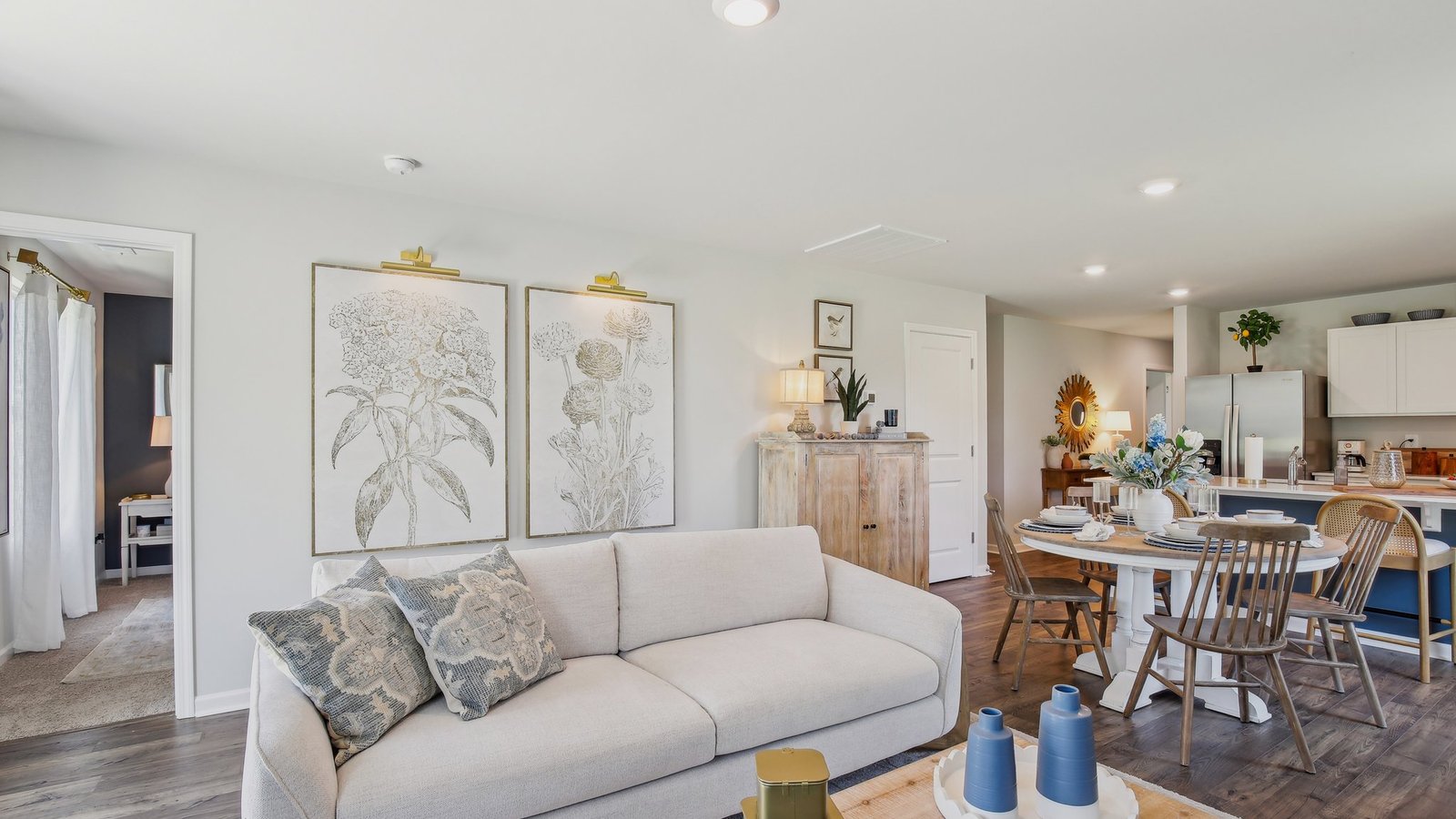 Living room in new, open-concept home with windows and natural lighting