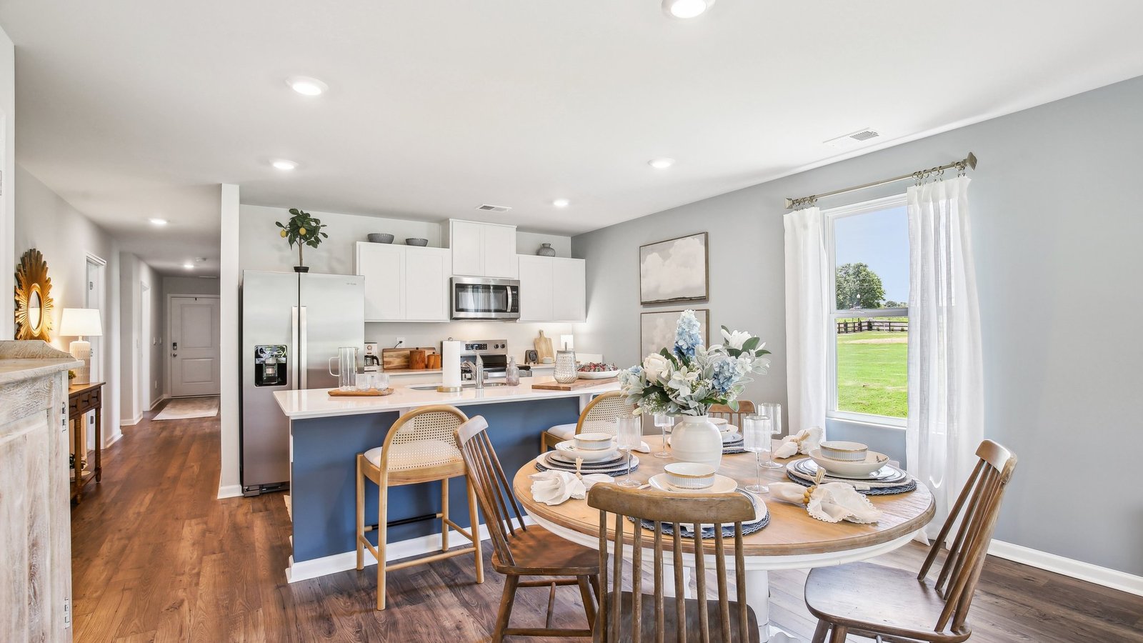Dining room in new, open-concept home with windows and natural lighting