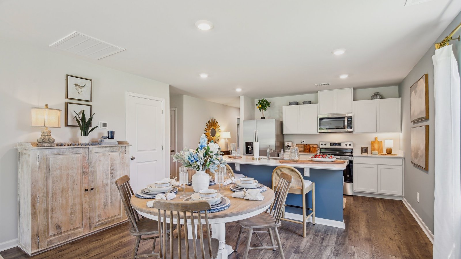 Dining room in new, open-concept home with windows and natural lighting