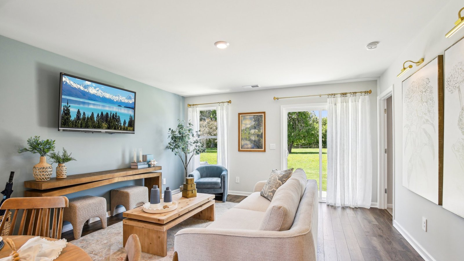 Living room in new, open-concept home with windows and natural lighting