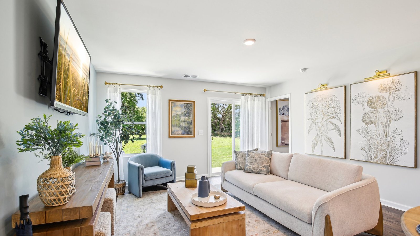 Living room in new, open-concept home with windows and natural lighting