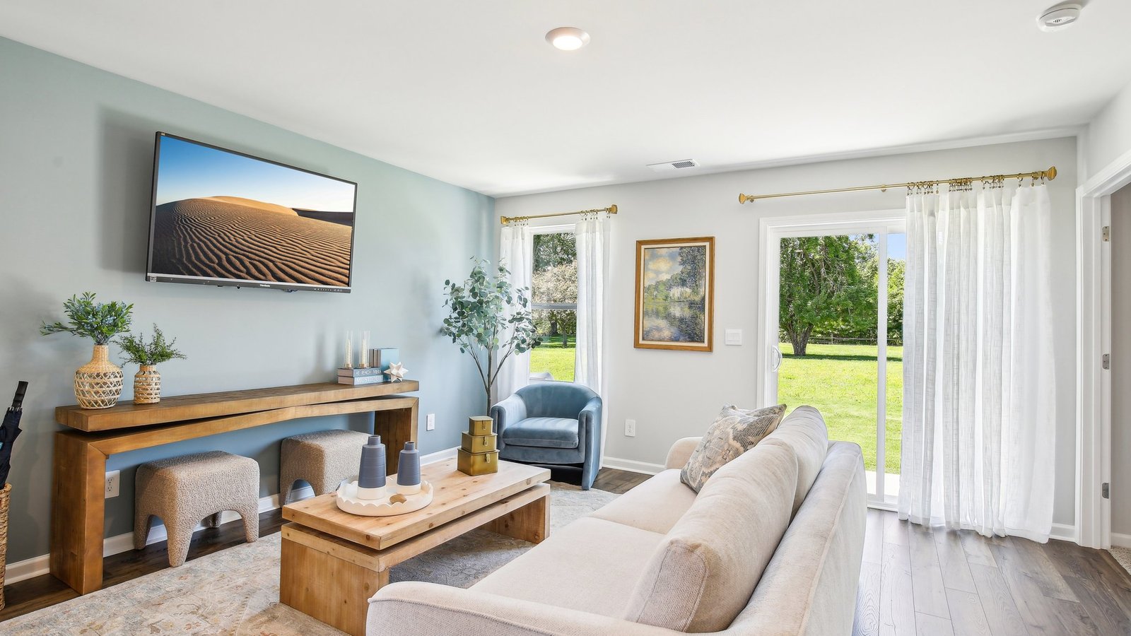Living room in new, open-concept home with windows and natural lighting