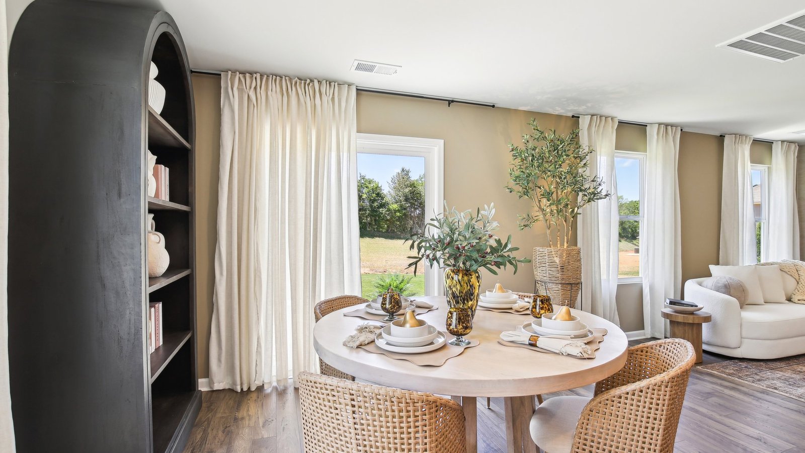 Functional dining area in D.R. Horton's new home with flow to central kitchen island, dining and living areas