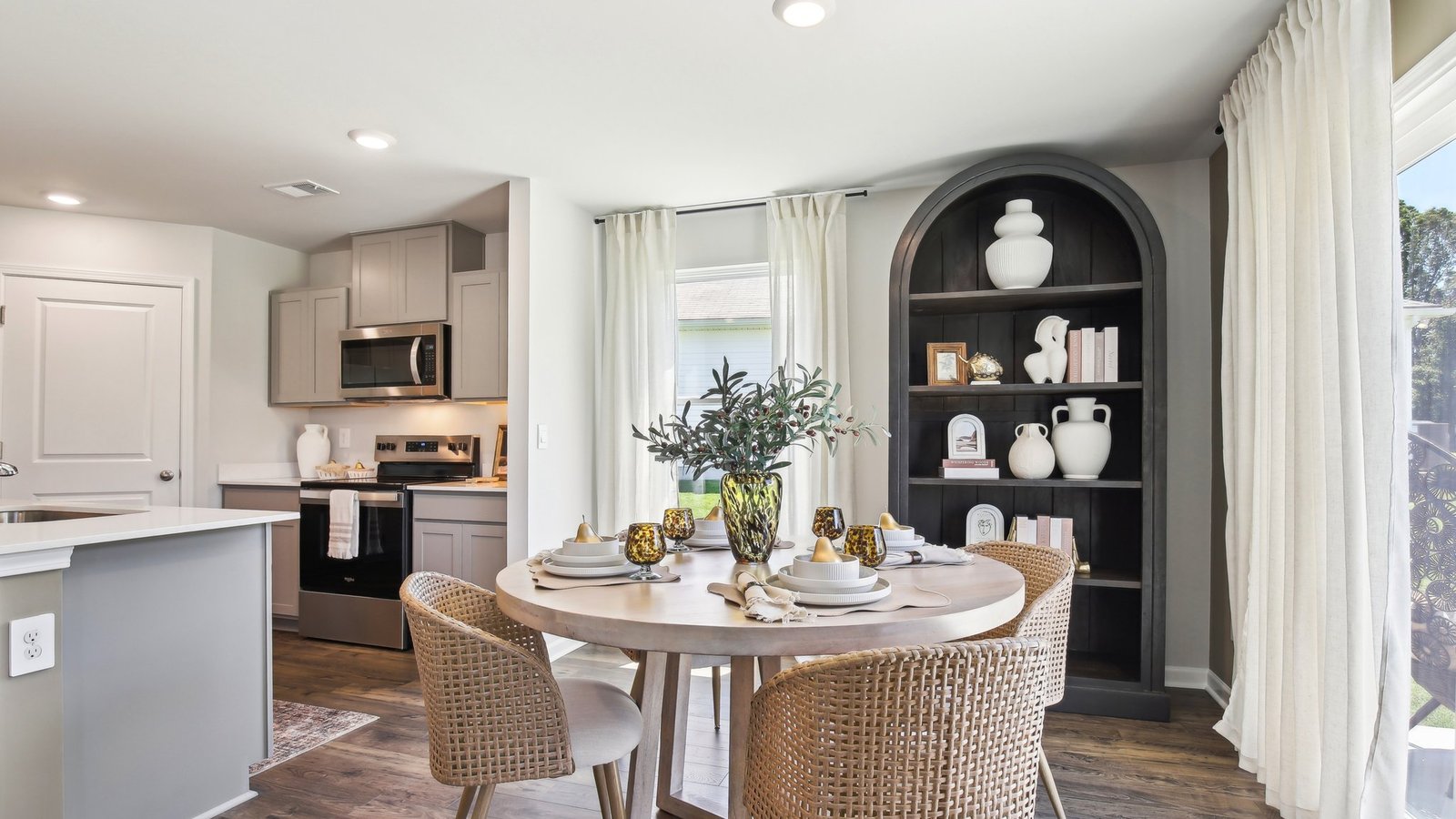 View from dining room into kitchen with island, pantry, new appliances and cabinet options at Parkside Point