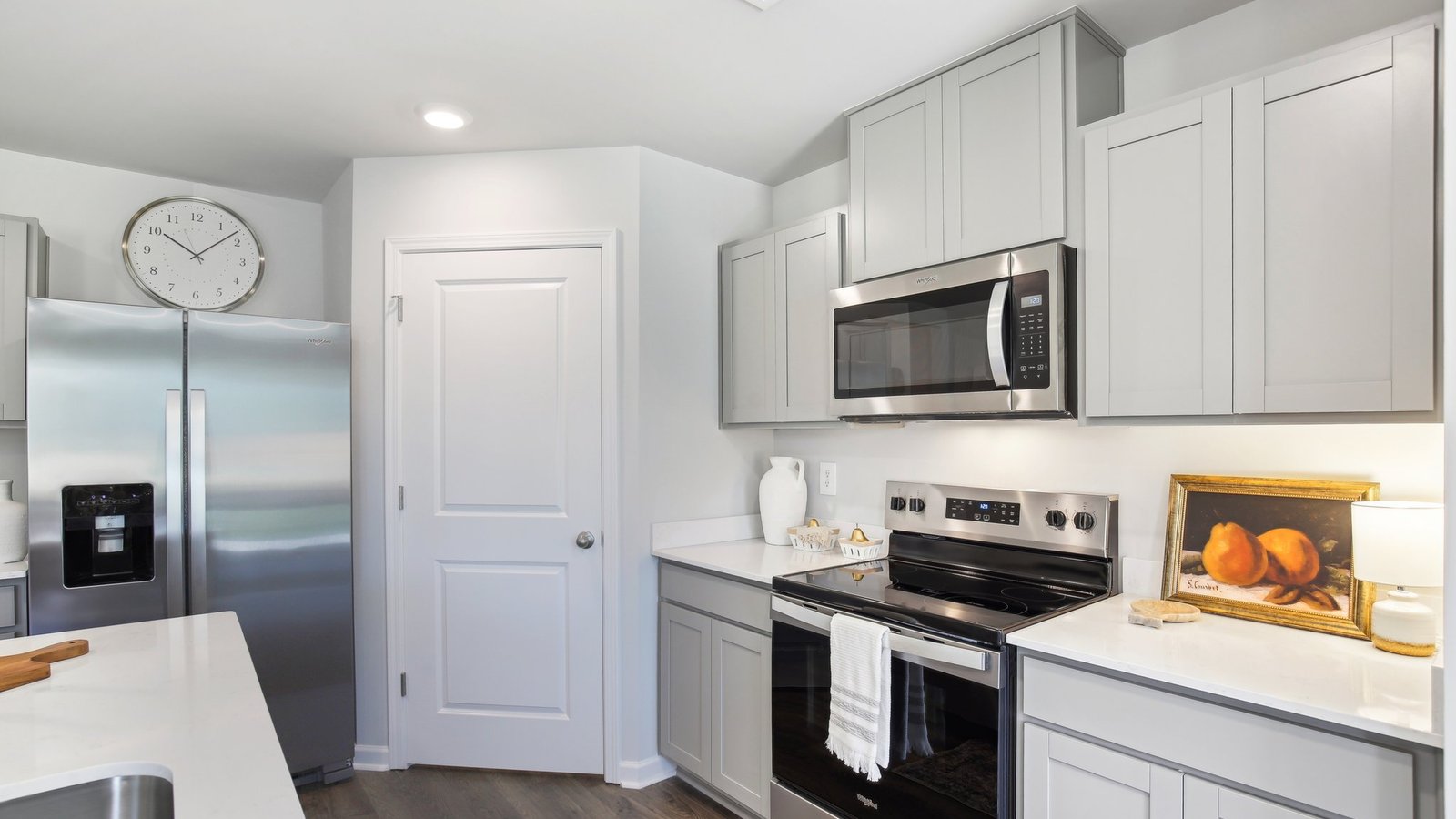 New appliances and larger kitchen island with seating anchor the kitchen, next to dining, great rooms, pantry, outside access
