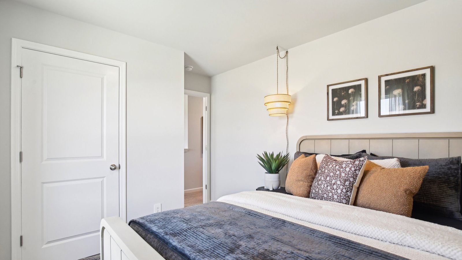 Secondary bedroom in Parkside Point showcases soft carpet, a single closet, soft window light, multi-use potential