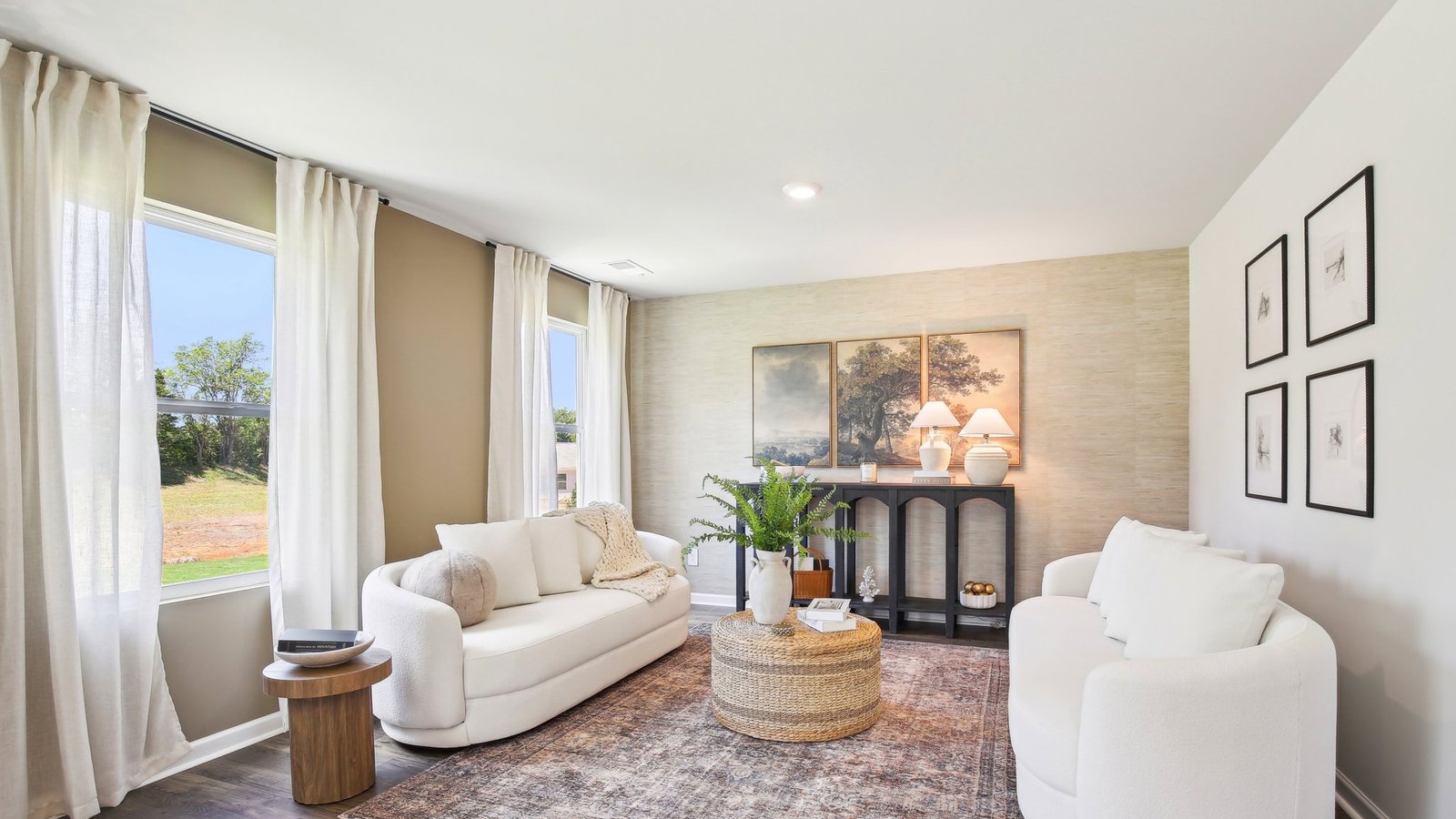 Living room in this new construction home features natural light, with fresh open concept flow to the kitchen, dining areas