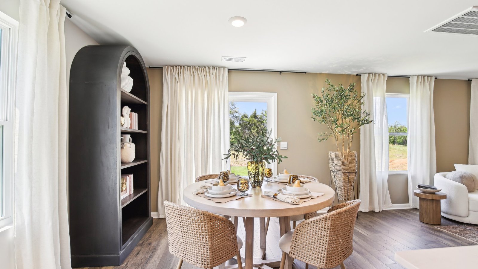 Dining room in new, open-concept home with windows and natural lighting