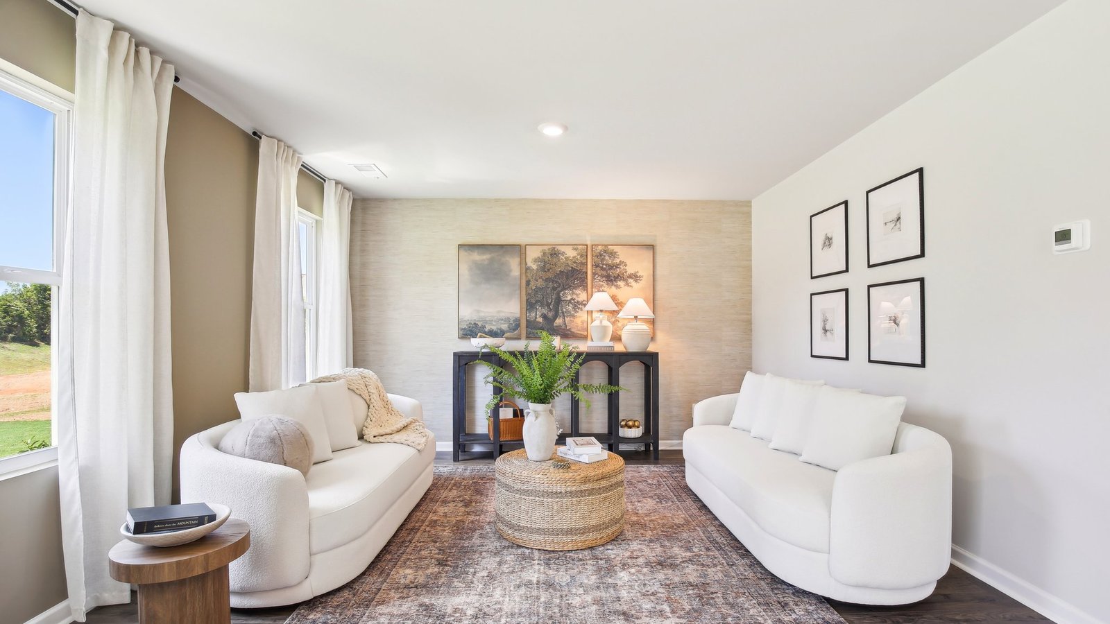 Living room in new, open-concept home with windows and natural lighting