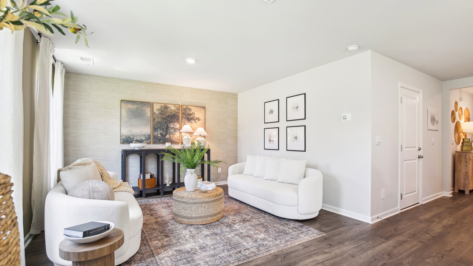 Living room in new, open-concept home with windows and natural lighting