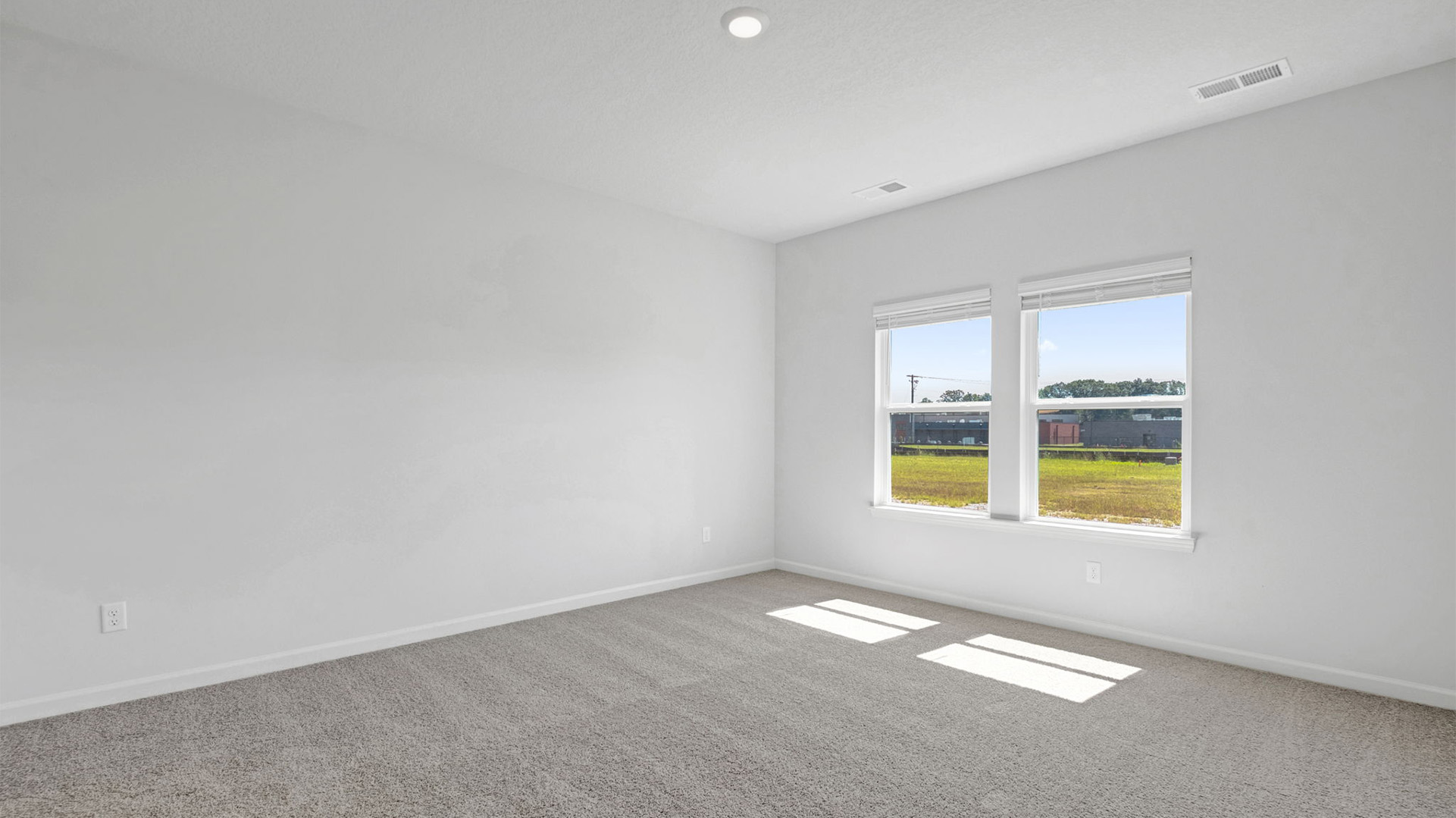 Primary bedroom positioned at the rear corner of the home for privacy
