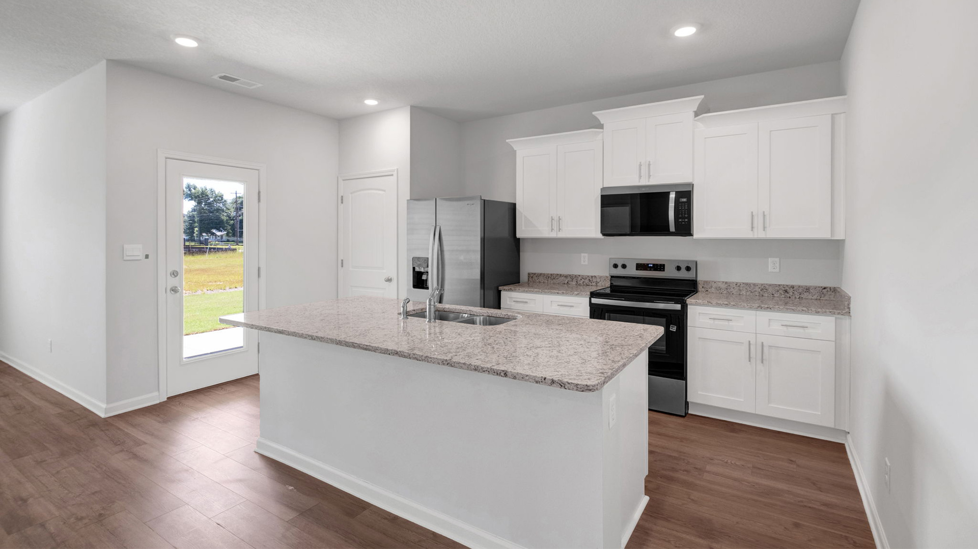 Kitchen area with light cabinets and stainles steel appliances