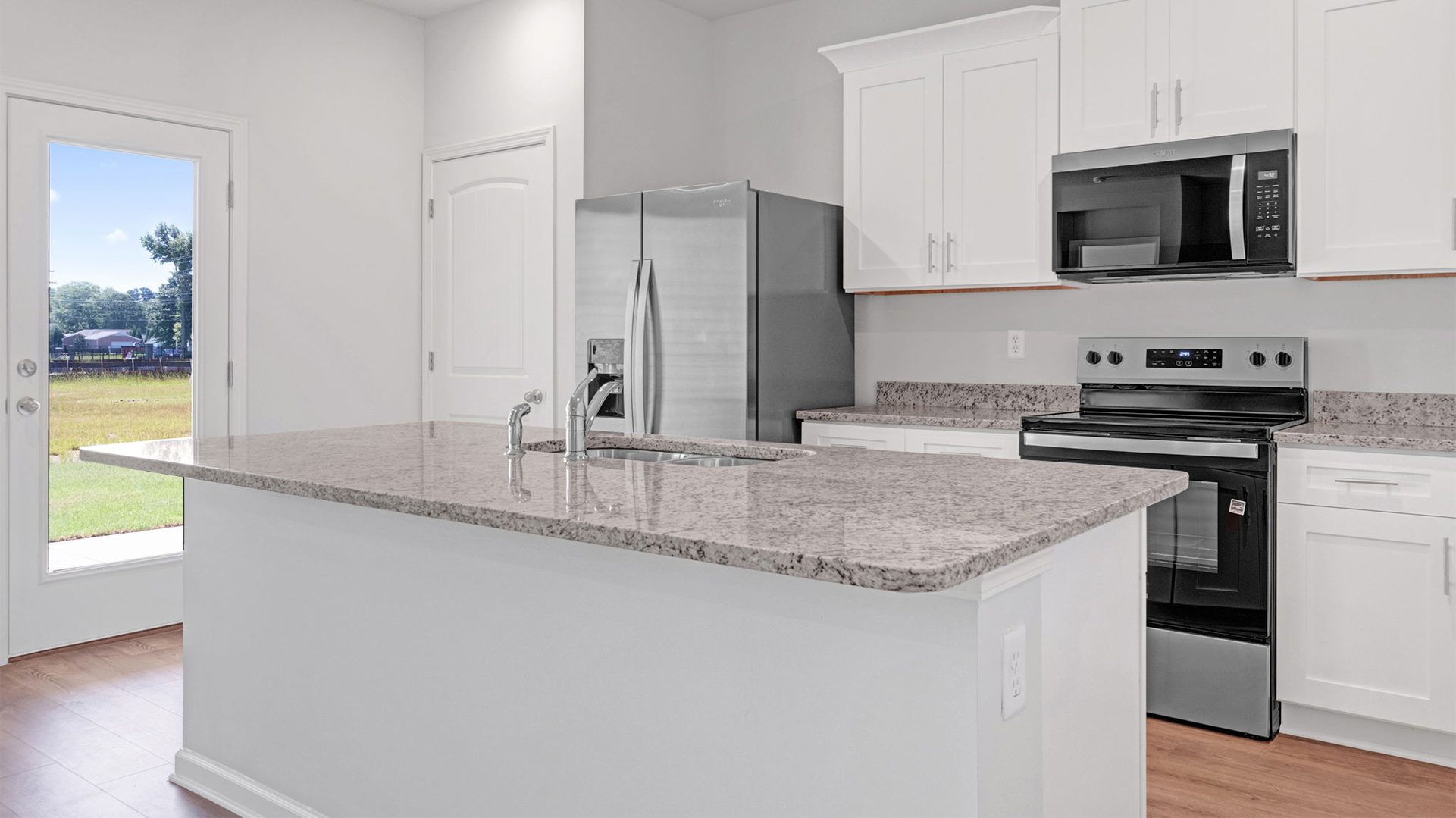 Kitchen area with close door access out to patio