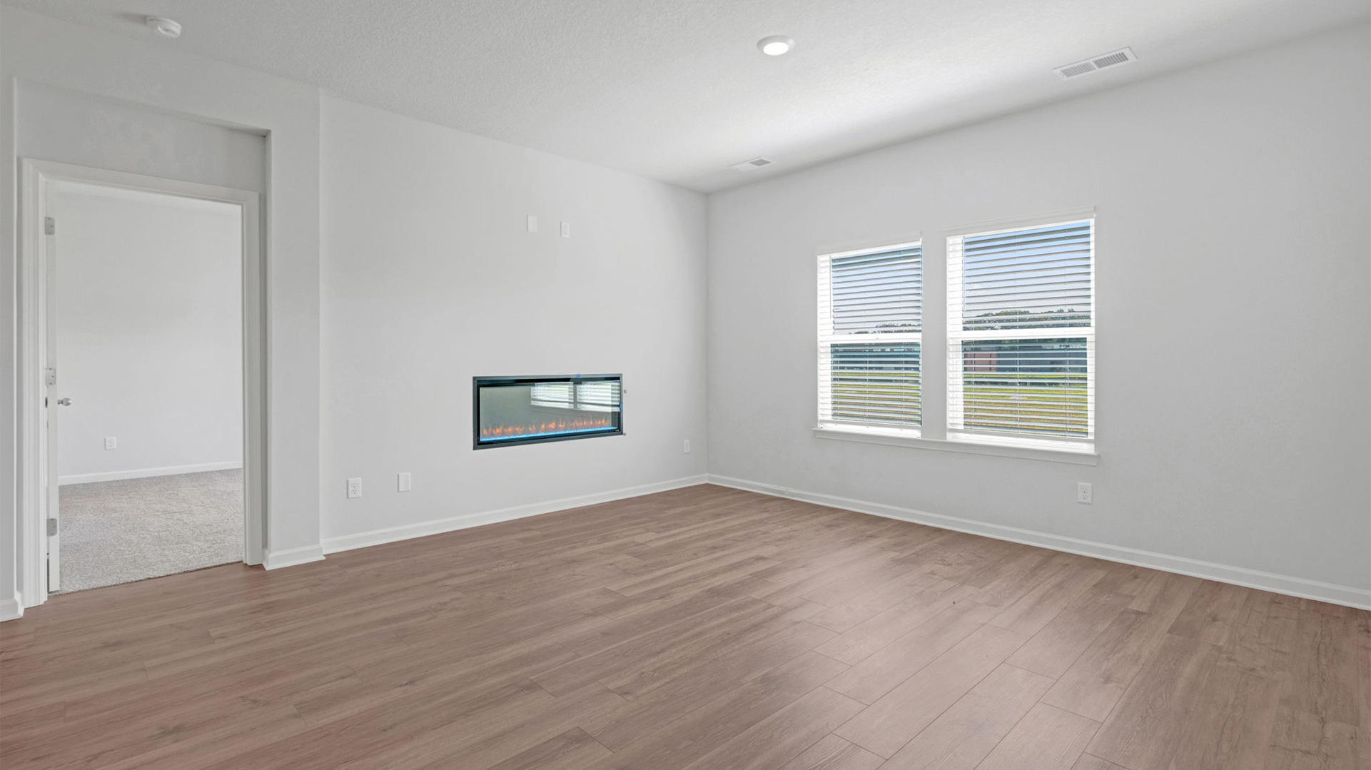 Living room with a double window overlooking the backyard