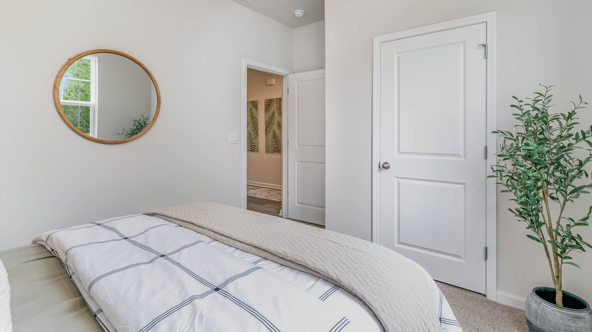 second bedroom with carpet flooring and light neutral paint in new home
