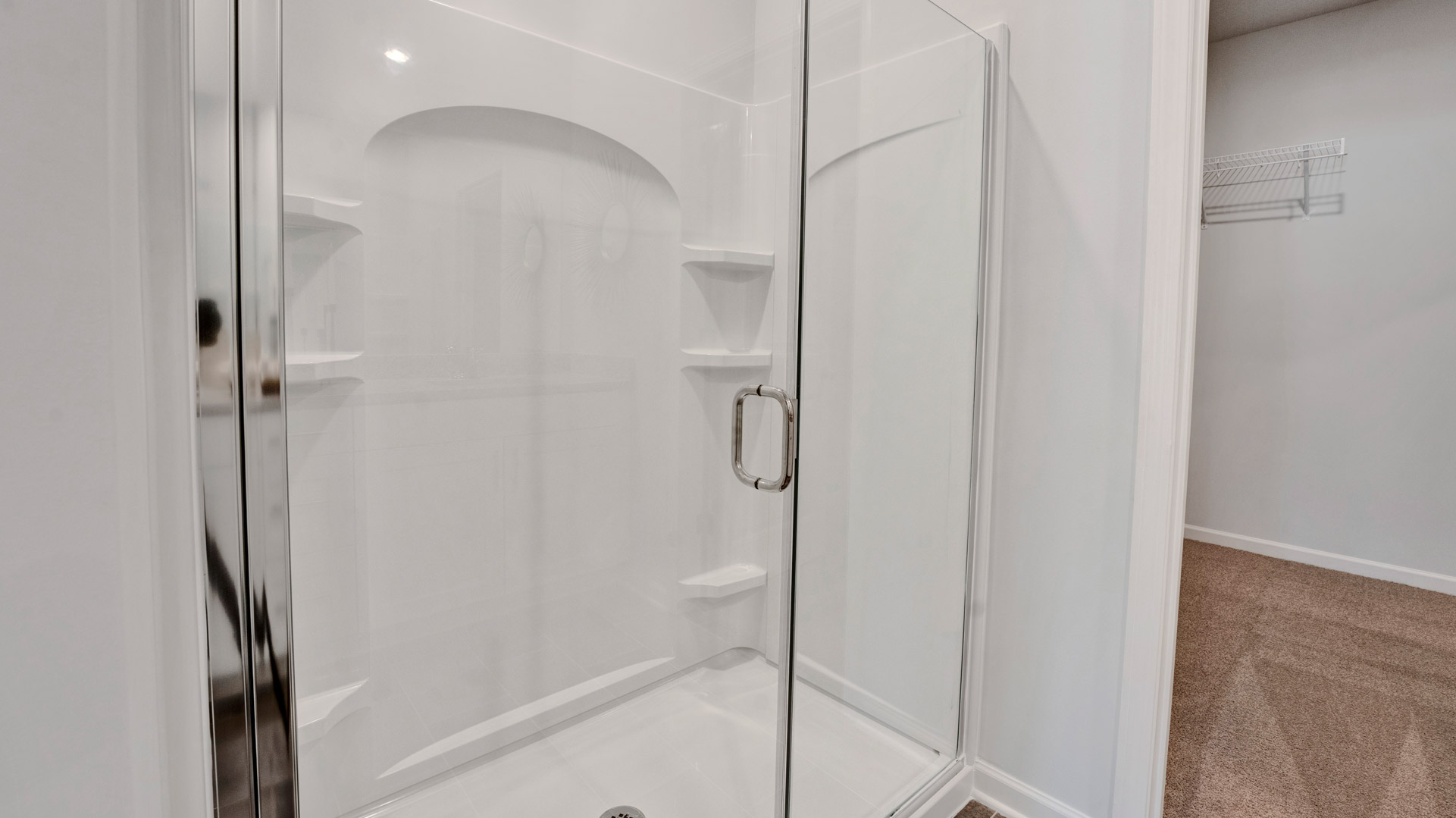 Glass enclosed walk in shower in primary