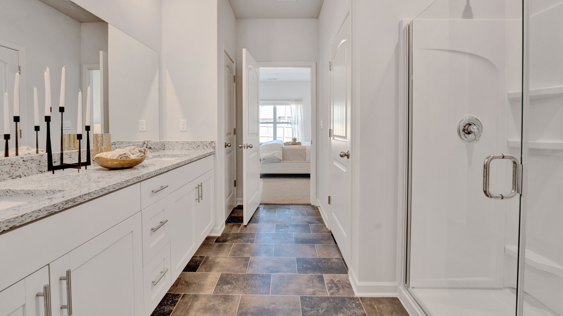 En suite primary with a privacy bathroom and a closet