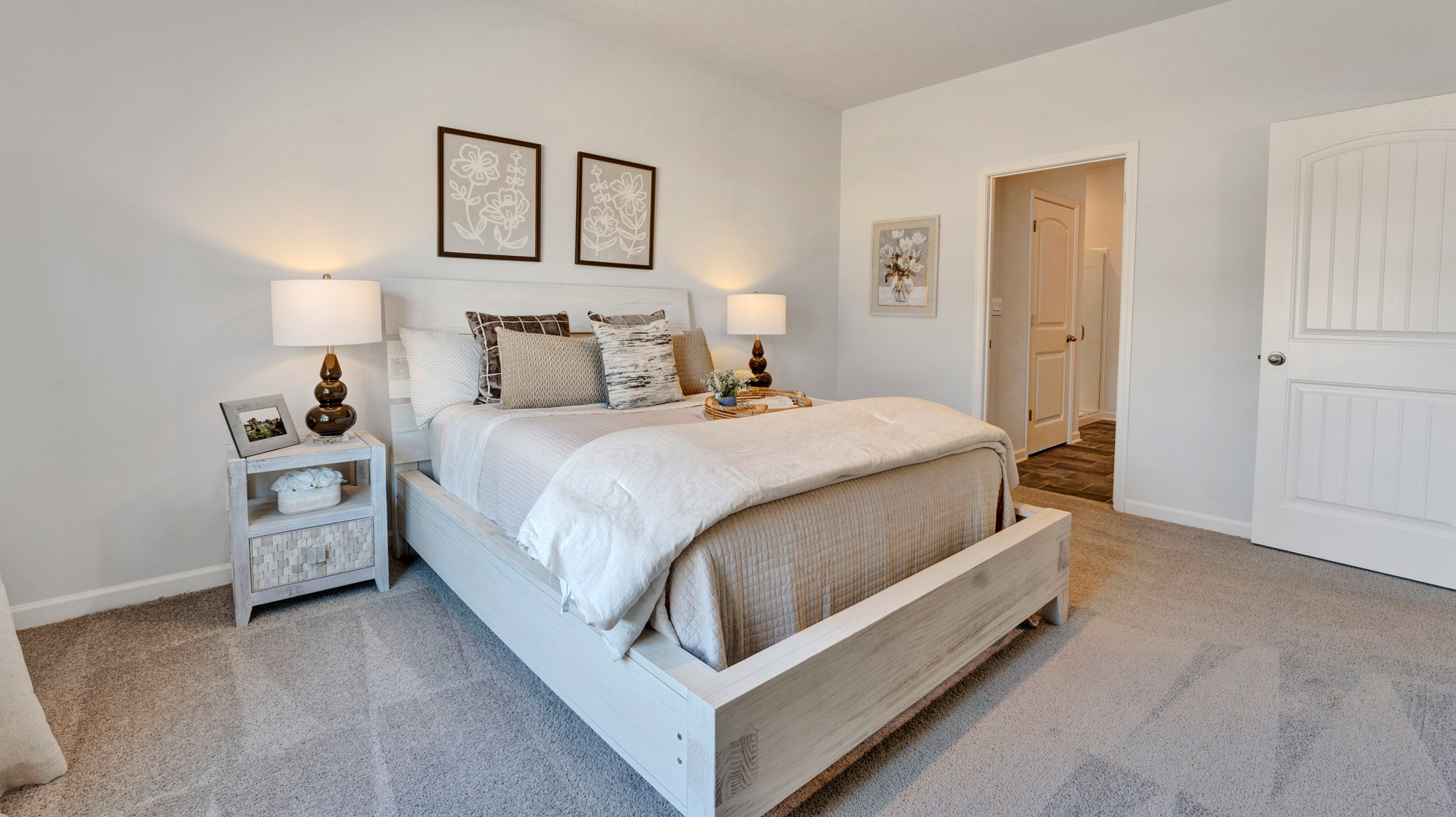 Primary bedroom with a large double window overlooking the backyard