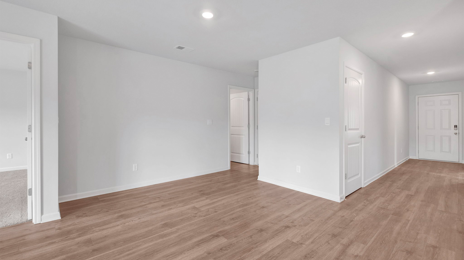 Dining area opens up at the end of entry hall