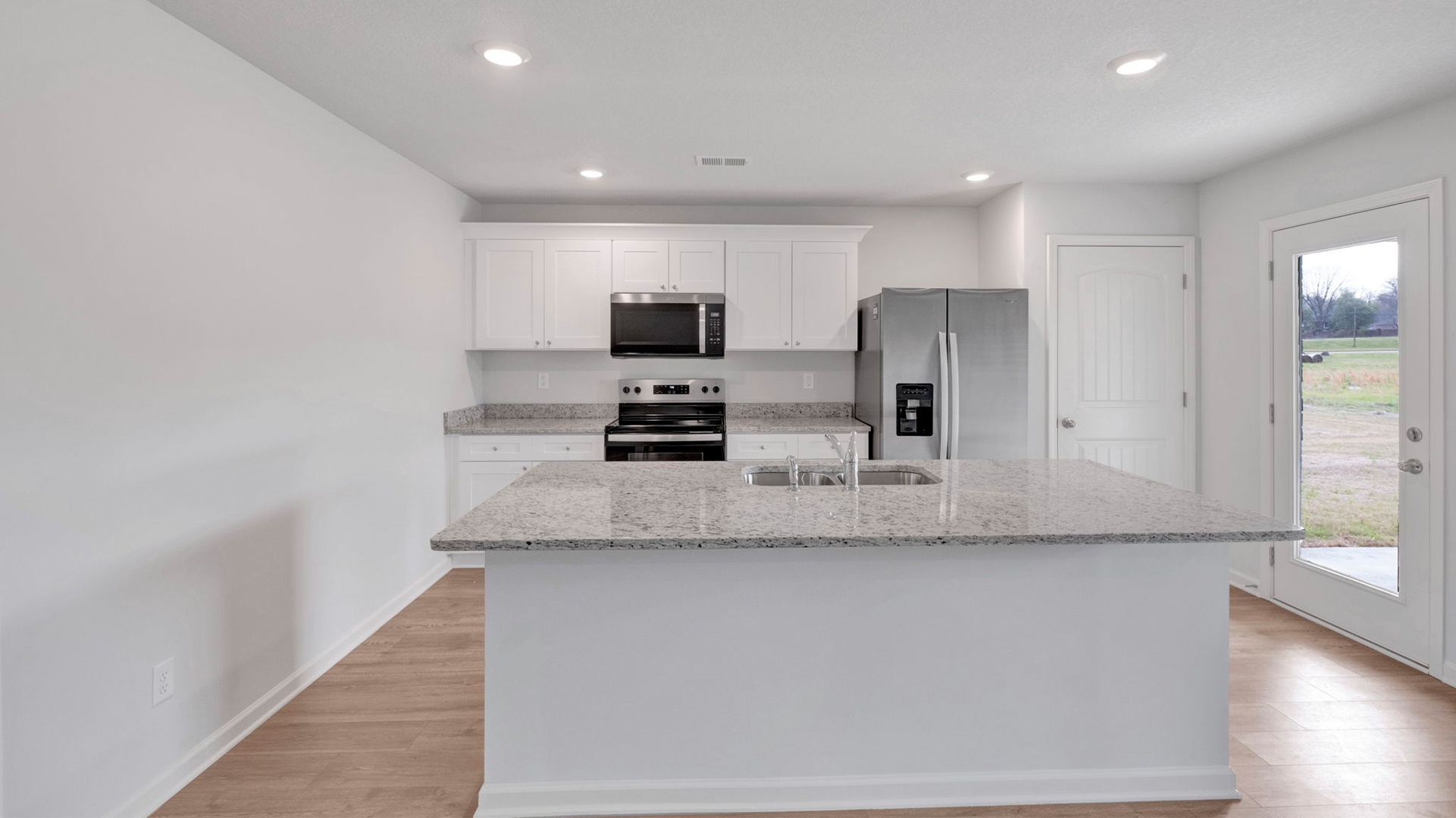 Beautiful kitchen with light cabinets and stainless steel appliances
