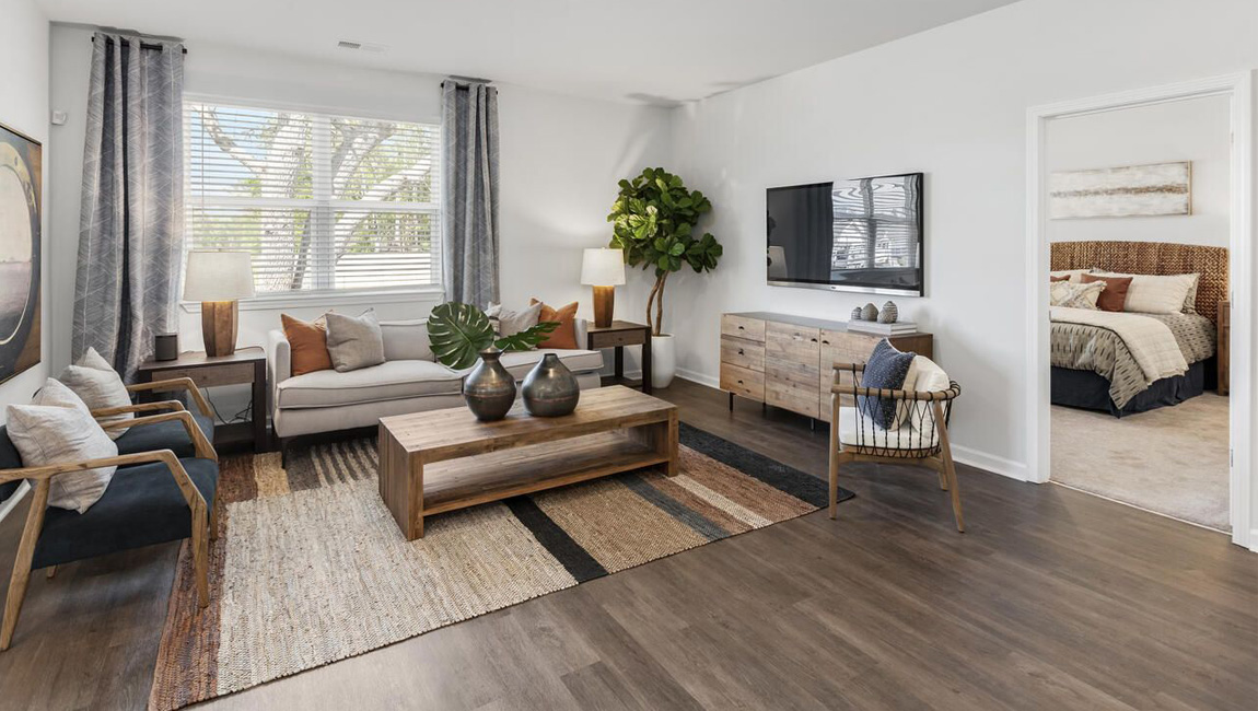 living room with laminate flooring and large window overlooking the back yard