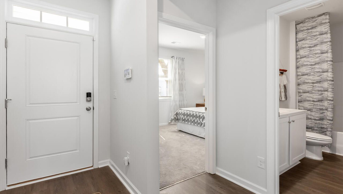 entryway with access to the front two bedrooms and shared bathroom