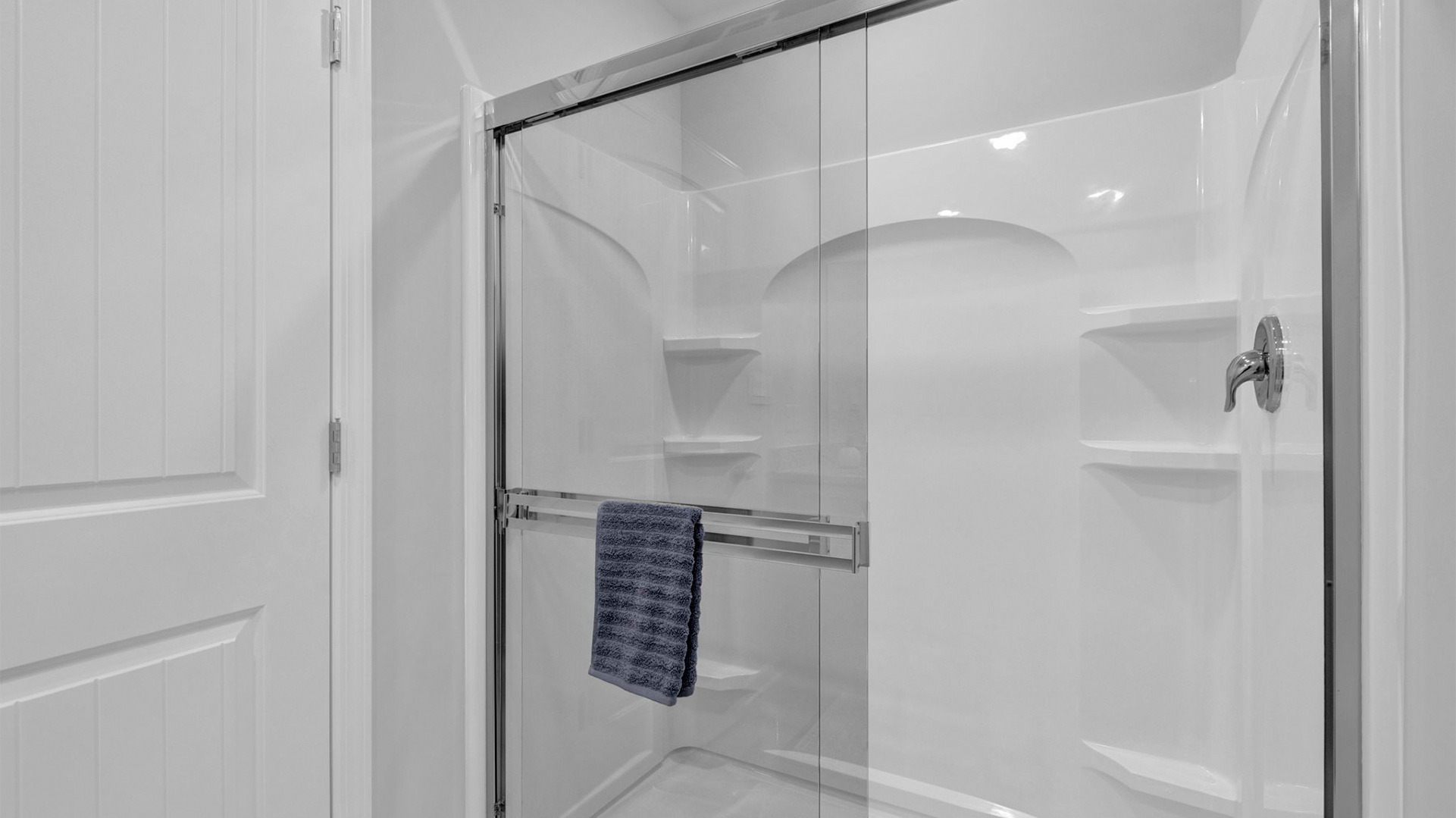 Glass enclosed walk in shower in the primary