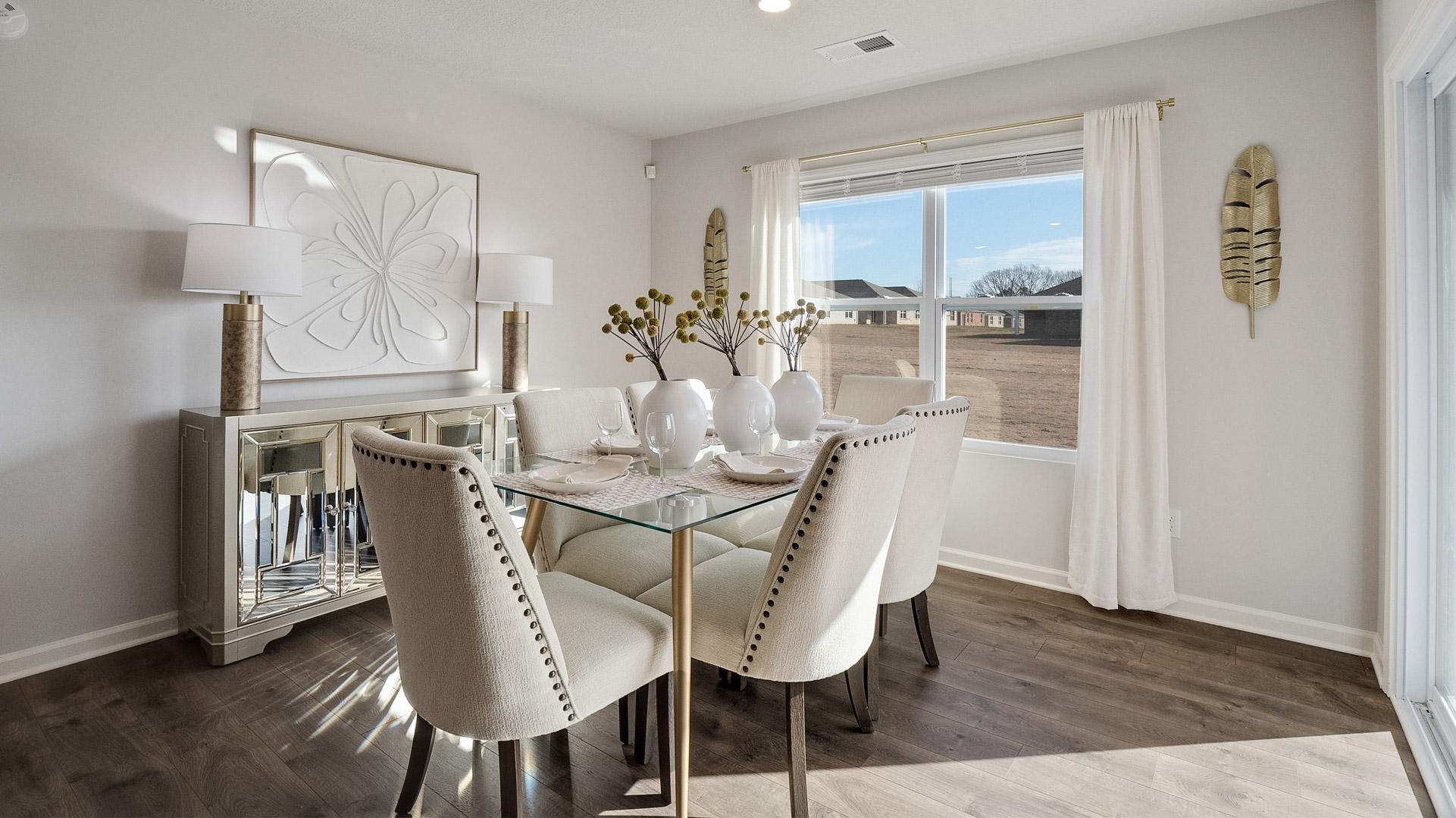Dining room with a large double window overlooking the backyard