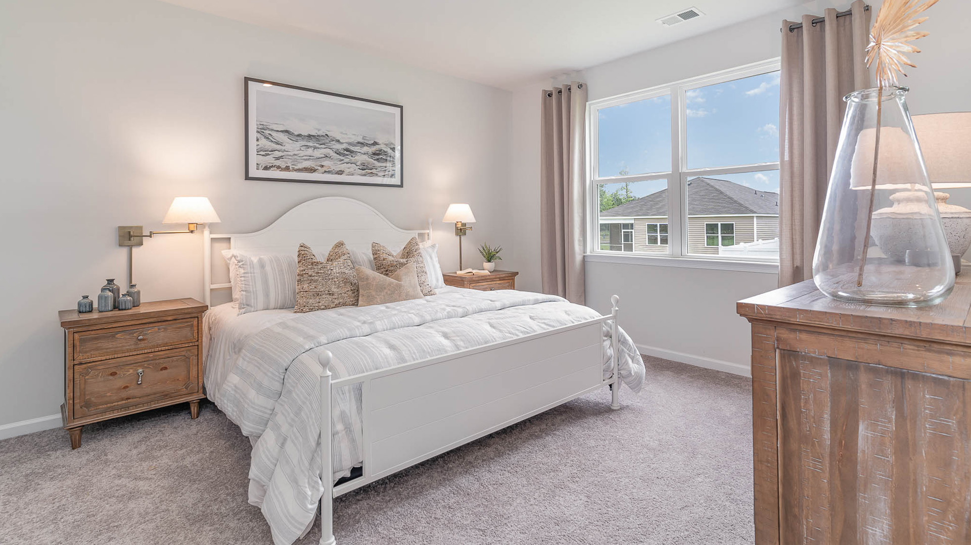 Primary bedroom with a double window overlooking the backyard