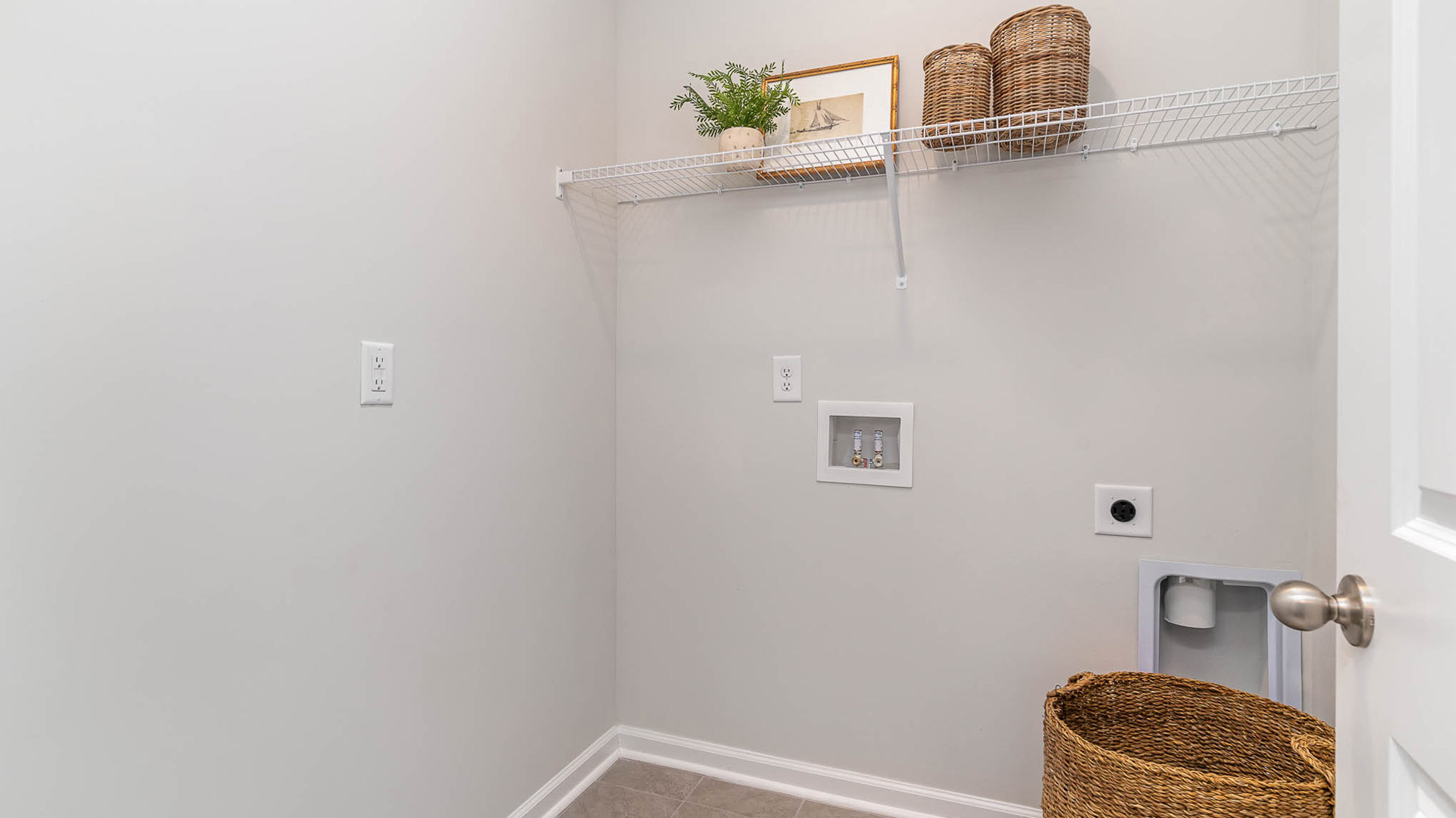 Laundry room with vinyl flooring and ventilated shelving