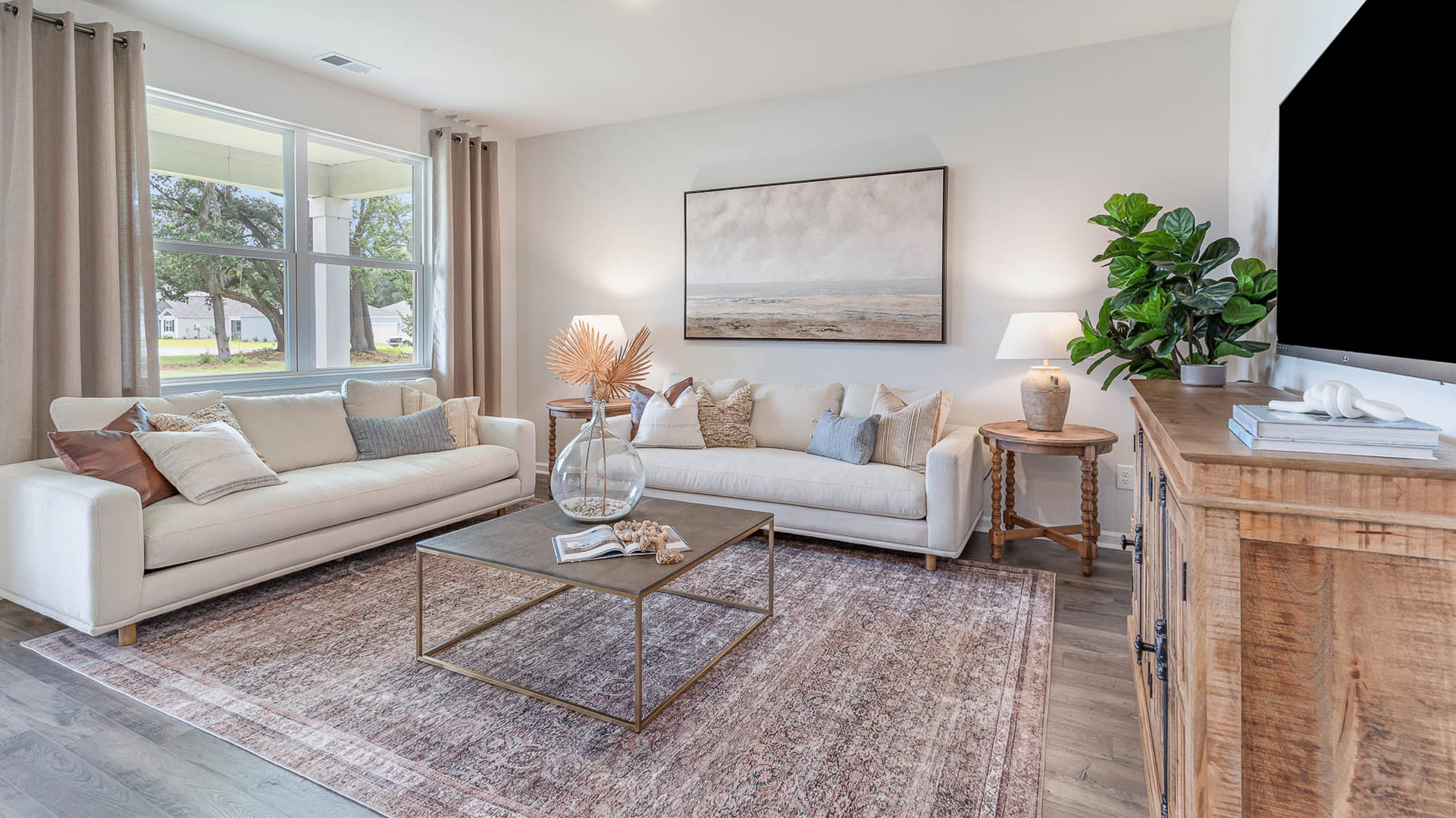 Living room with a large double window overlooking the backyard