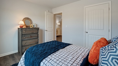 Second bedroom with vinyl flooring and neutral painted walls