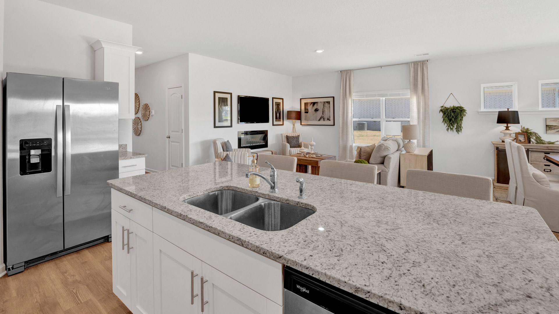 View from kitchen into the dining and living areas, backyard area, showing fresh open design at Twin Lakes