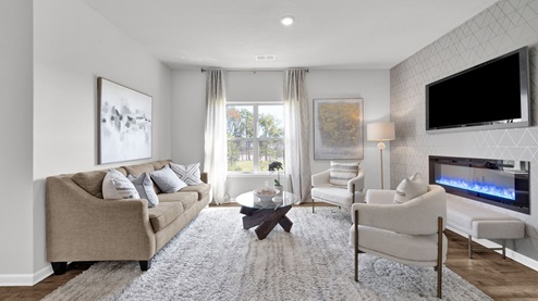 Spacious living room with vinyl flooring and neutral walls