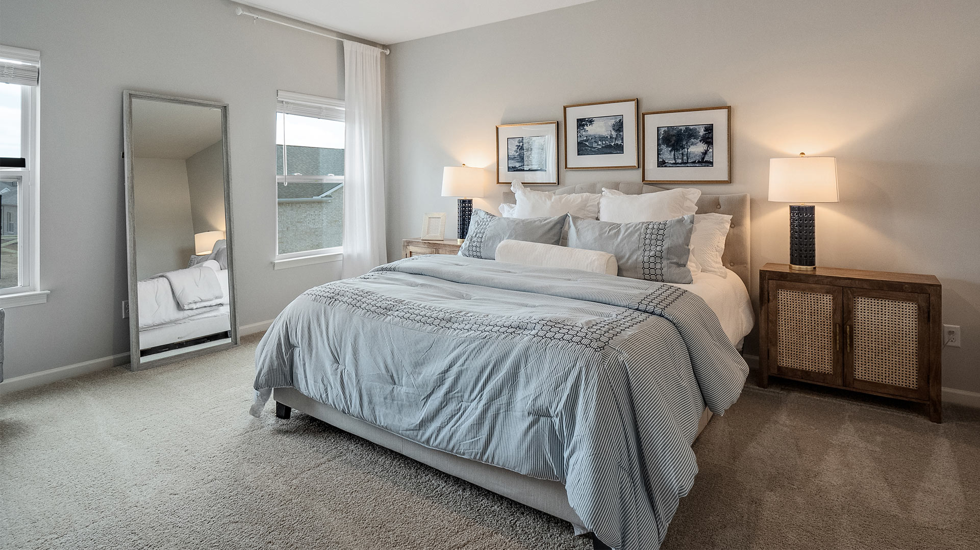 Primary bedroom with two tall window overlooking the backyard