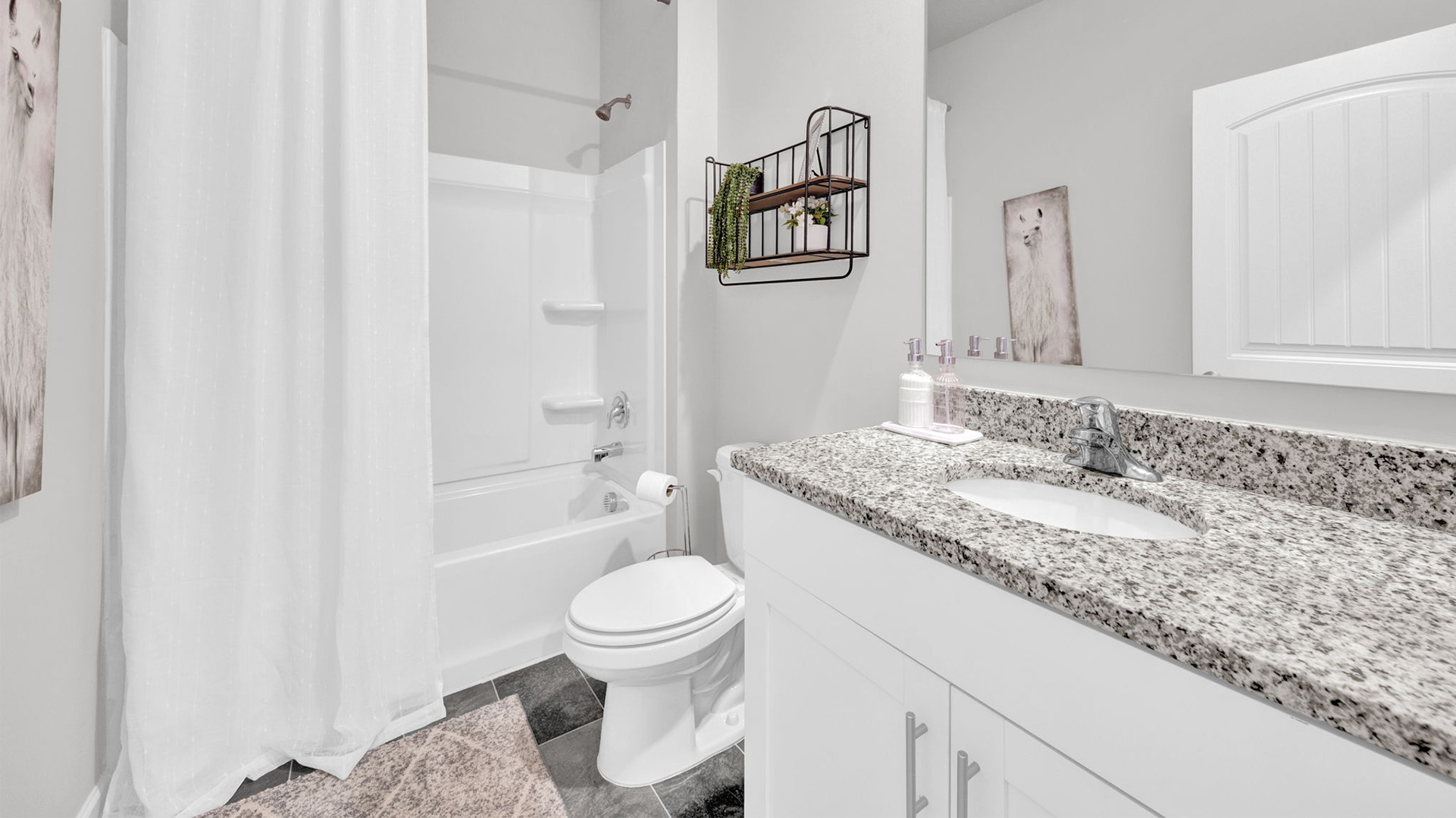 Second bathroom with a single vanity and an acrylic tub/shower insert