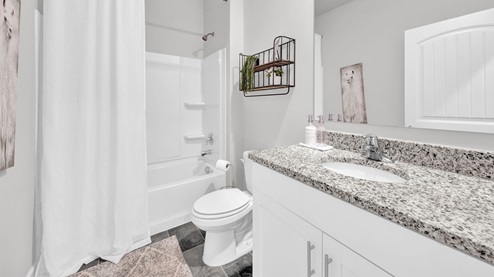 Second bathroom with a single vanity and an acrylic tub/shower insert