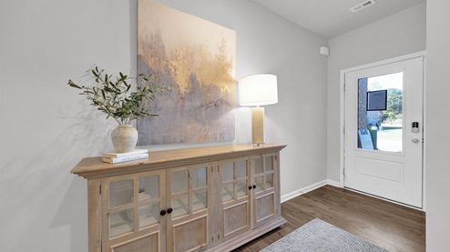 Front door entryway of the Twin Lakes model with natural light from front door glass insert