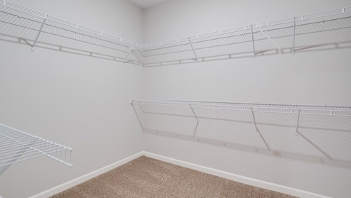 Spacious primary closet with ventilated shelving