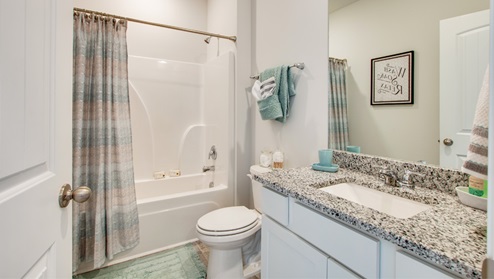 Second bathroom with a single vanity and an acrylic tub/shower insert