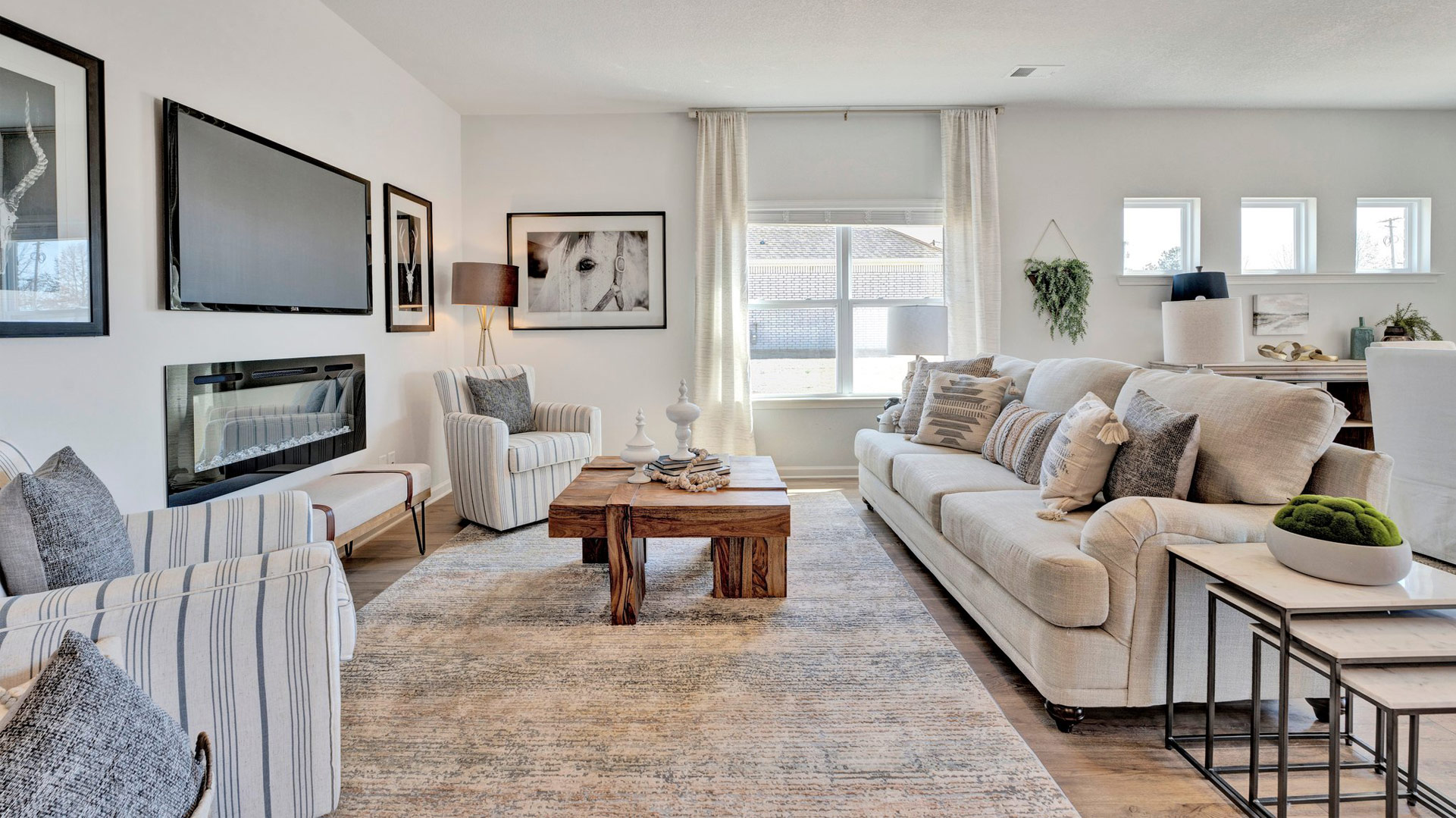 spacious living room has a large double window along the side wall